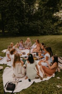 Women's circle gathered outside in nature