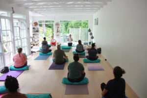 Lady facilitating a meditation class