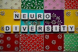 Background of colourful tiles with the word Neuro Diversity on it