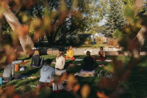 People sitting and meditating outside